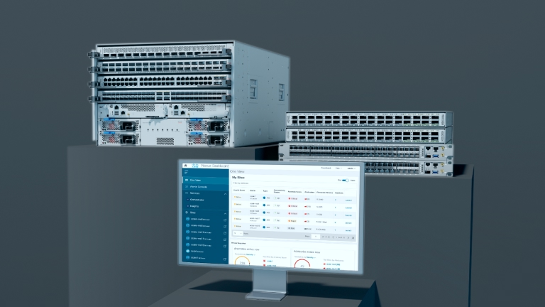 Cisco modular and fixed-configuration switches alongside a monitor displaying the Nexus Dashboard interface.