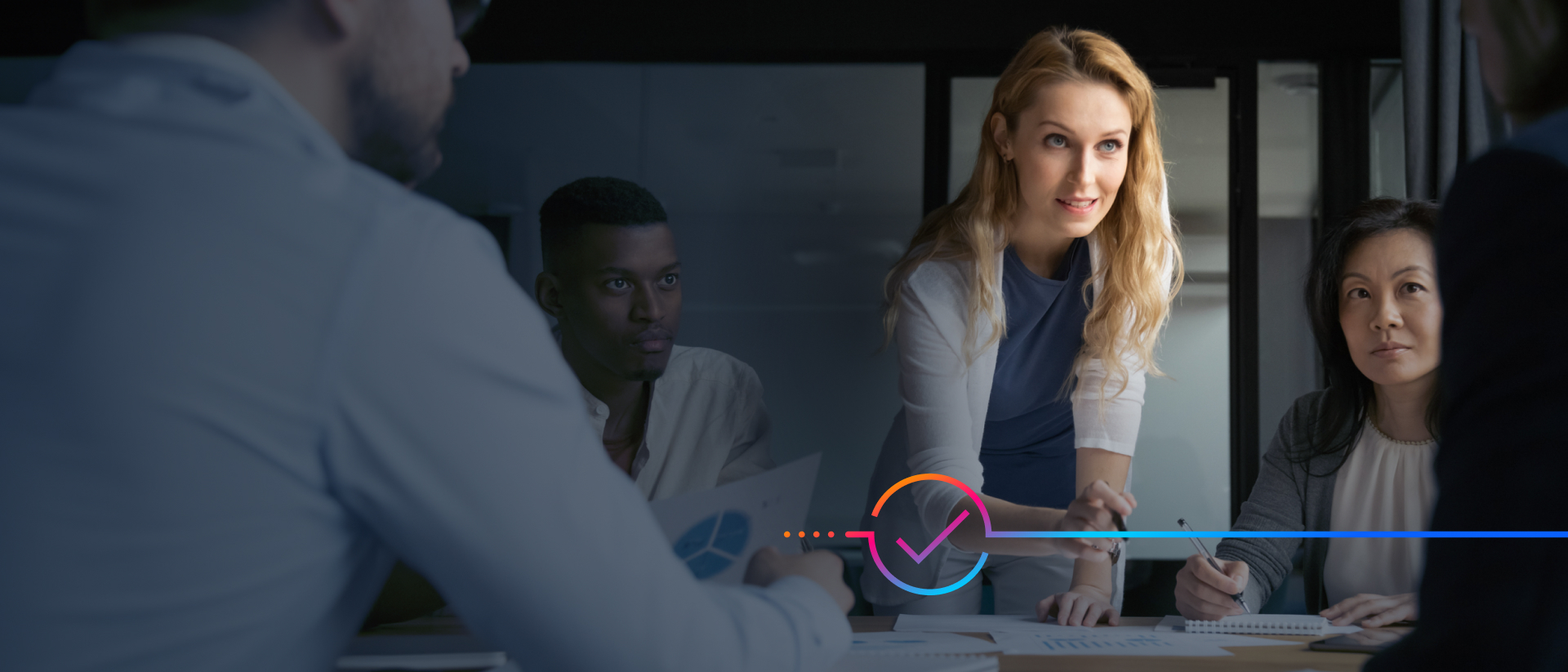 ​​​​Businesspeople collaborating around a table in a conference room.​​