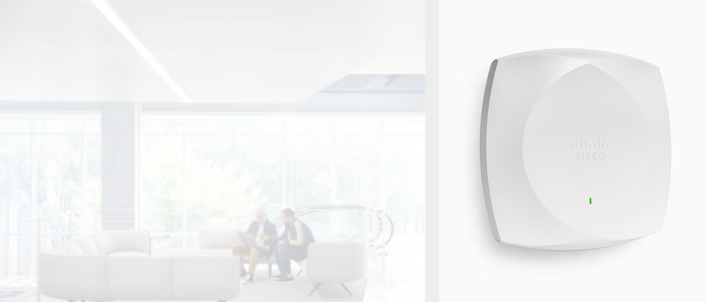 Close up of a CW Model Family Meraki Access Point with people in the background.