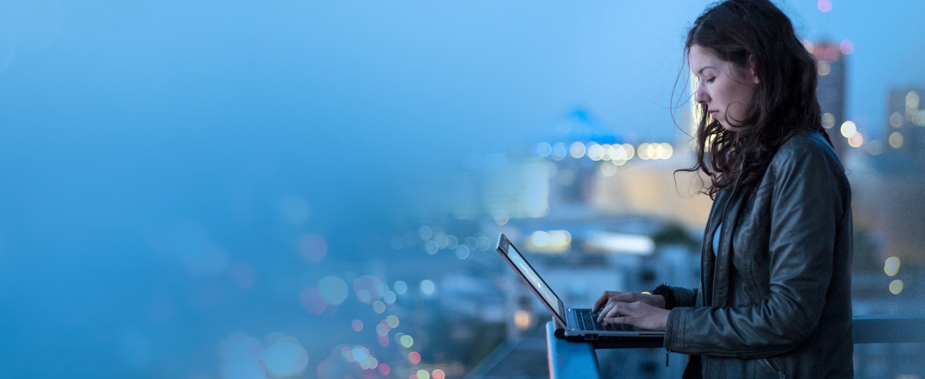 A person standing and working on Laptop