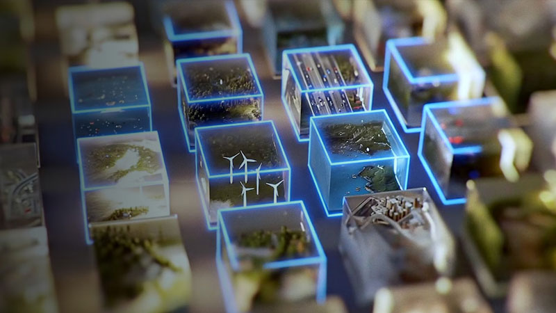 Grid of glowing digital cubes containing miniature scenes of wind turbines, cities, and nature.