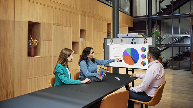 Professionals reviewing a presentation in a conference room