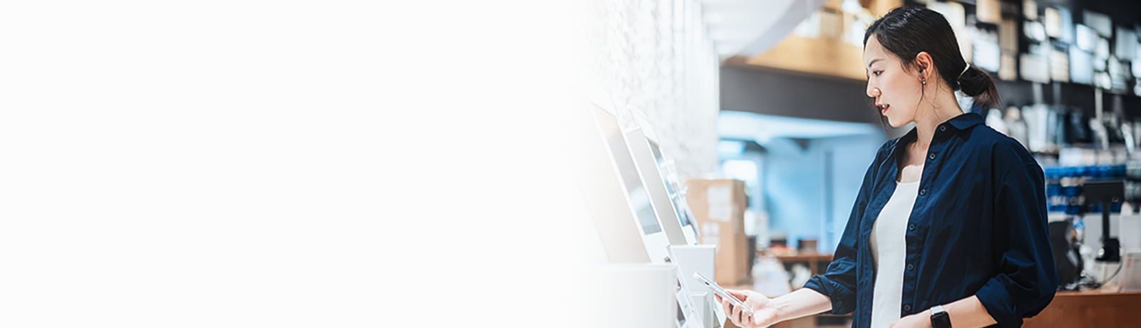 Woman at a self-checkout kiosk