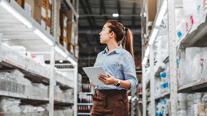 Woman taking inventory in distribution center