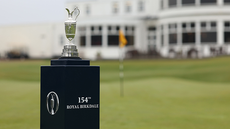 The Claret Jug trophy sits atop a black display pedestal