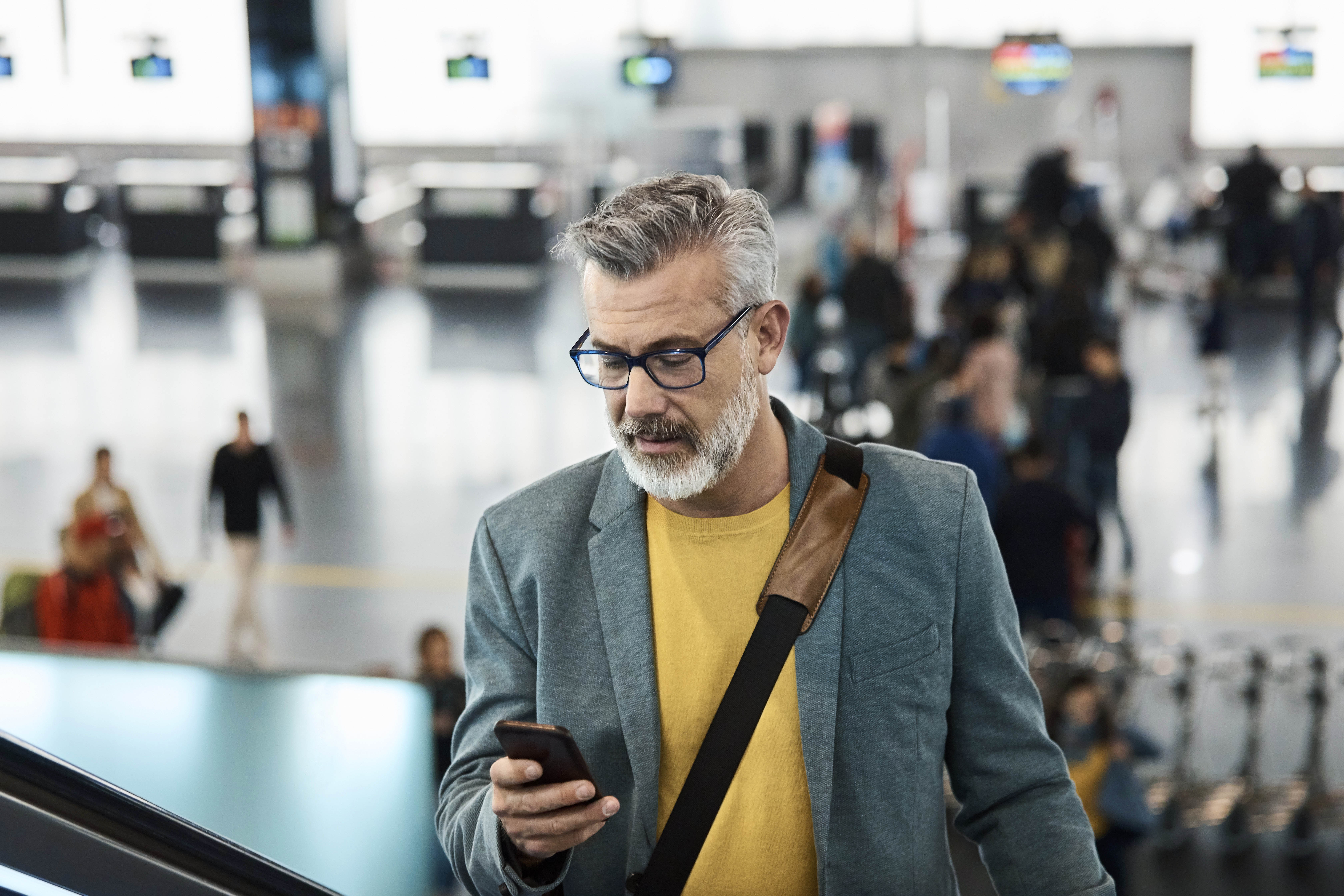 Man is on phone inside transportation terminal