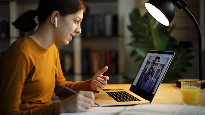 Woman watching a live demo on her laptop